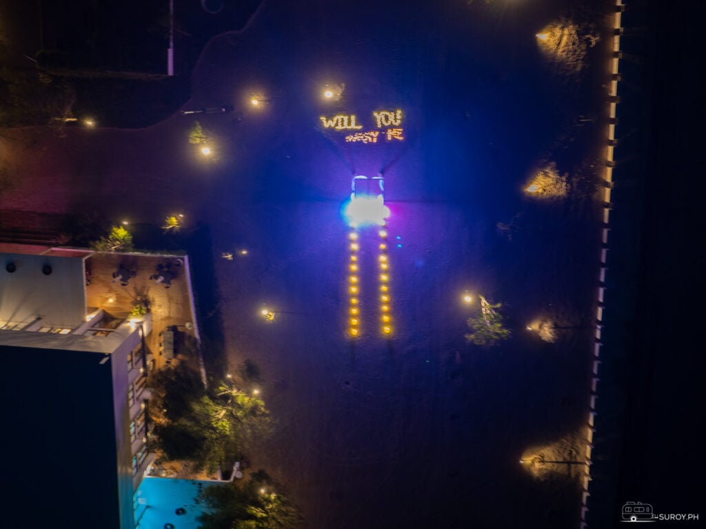 A magical proposal setup on the sands of Kandaya Resort, with glowing lights and “Will You Marry Me?” spelled out—an unforgettable moment under the stars.
