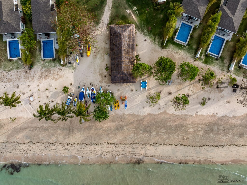 The beachfront at Kandaya Resort, where guests can enjoy water sports like kayaking, paddleboarding, and more—ideal for those seeking adventure amidst nature.