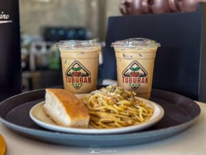 Tuburan Café’s signature iced coffee paired with their mouthwatering pasta and bread—a perfect combination.