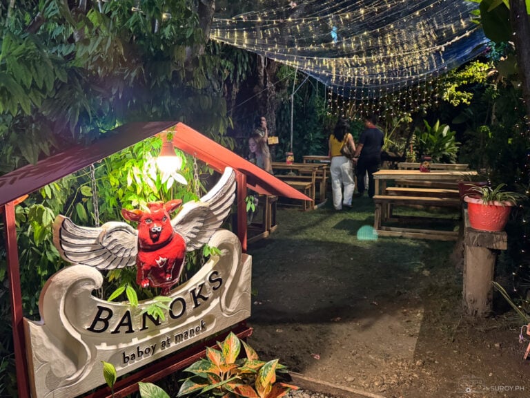 Discover the enchanting outdoor dining area at Banoks, complete with rustic wooden tables and string lights, for a unique dining experience.