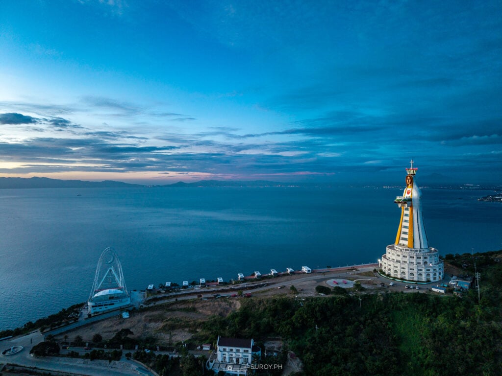 Twilight serenity at Montemaria Shrine. As the lights illuminate the statue, the peaceful surroundings invite quiet contemplation.