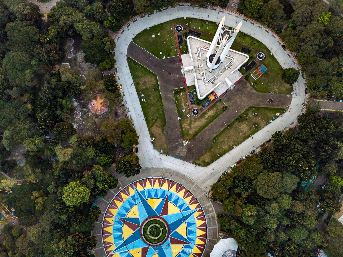 A top-down view of the majestic Quezon Memorial Shrine alongside the vibrant circular plaza, symbolizing unity and the rich cultural heritage of the Philippines.