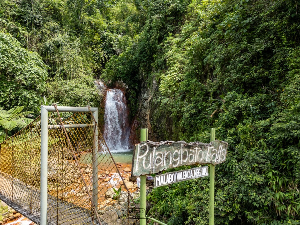Cross the hanging bridge for the best panoramic views of Pulang Bato Falls!