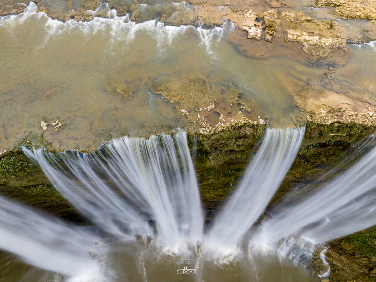 Overhead close-up drone photo showing flowing water patterns at the top of Niludhan Falls.