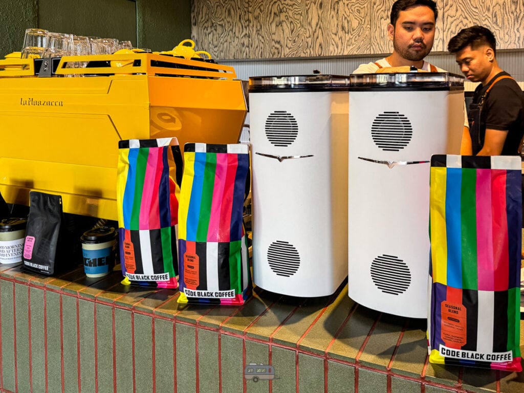 Colorful Code Black Coffee bags and yellow espresso machine at Punched Coffee Cebu.