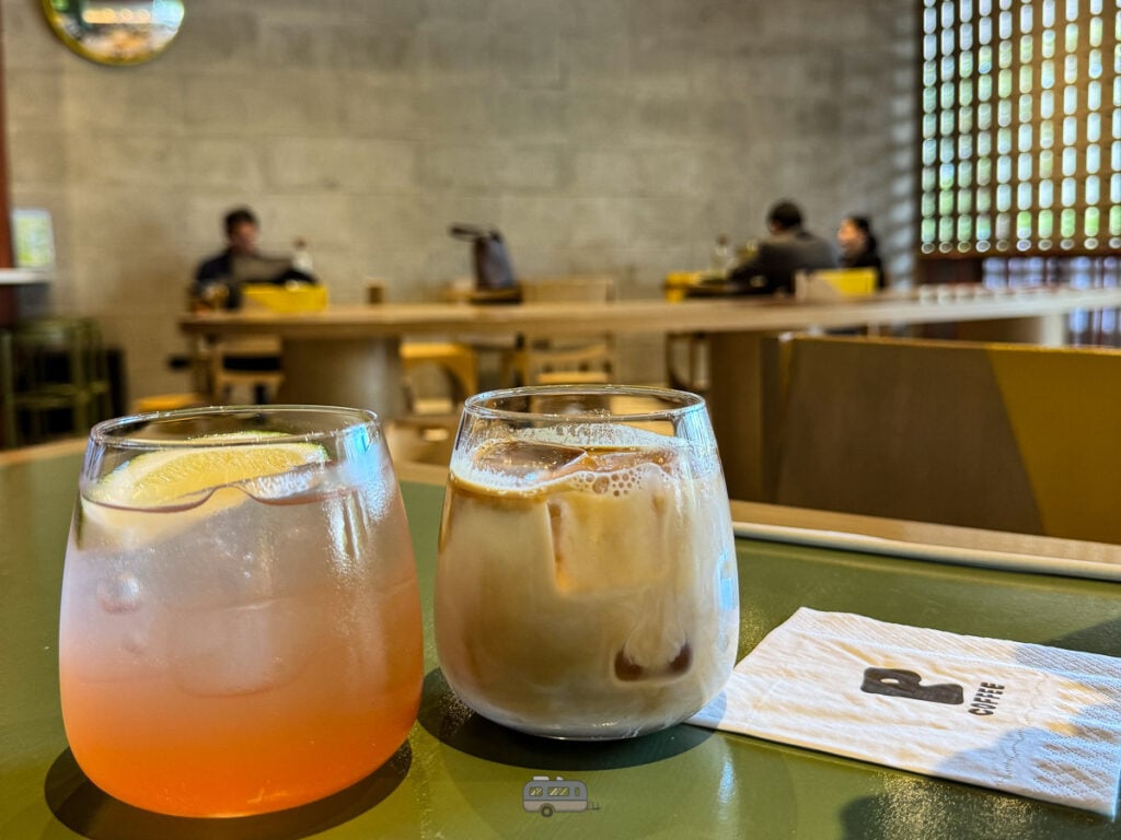Two signature drinks at Punched Coffee – citrus soda and iced latte on a table.