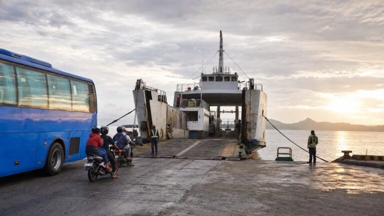 RORO ferry, bus, and motorcycles at a provincial port at dawn