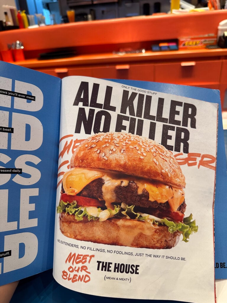 The 8Cuts menu book open at the all killer no filler page introducing The House blend, described as mean and meaty
