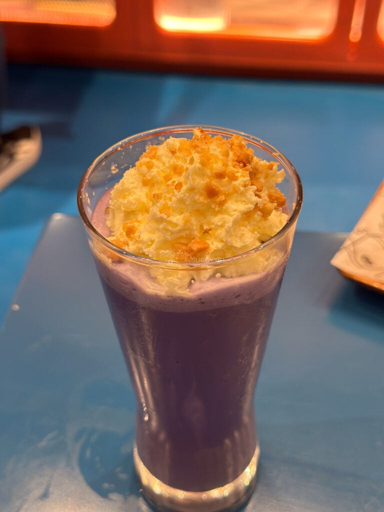 A tall purple ube shake topped with cheese foam at 8Cuts SM City Cebu
