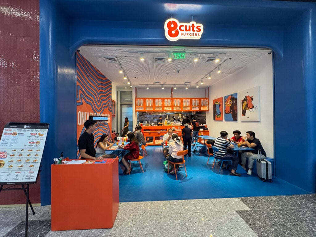 The blue and orange 8Cuts storefront on the Upper Ground of the North Wing at SM City Cebu with diners inside