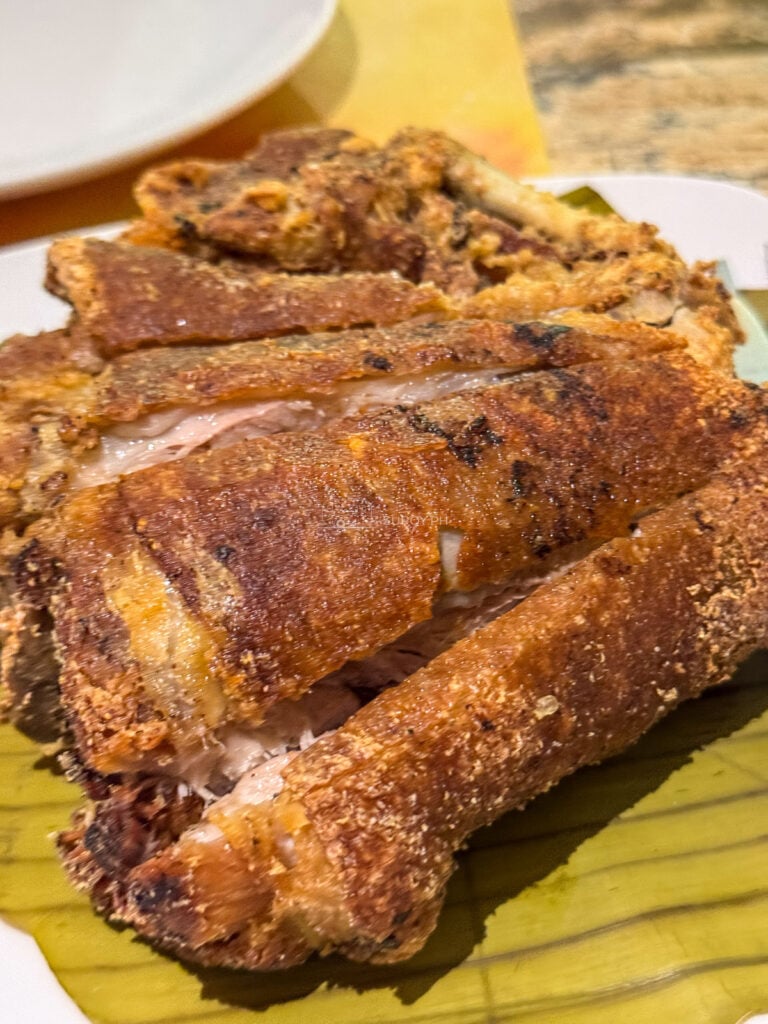 Close view of blistered crispy pata skin split along the bone at Alejandro's Crispy Pata Cebu