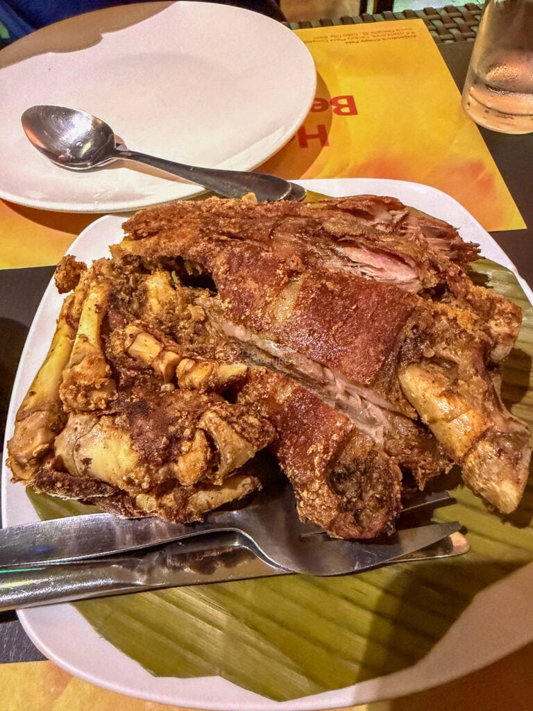 A stacked crispy pata on banana leaf photographed in July 2026 at Alejandro's Crispy Pata Cebu