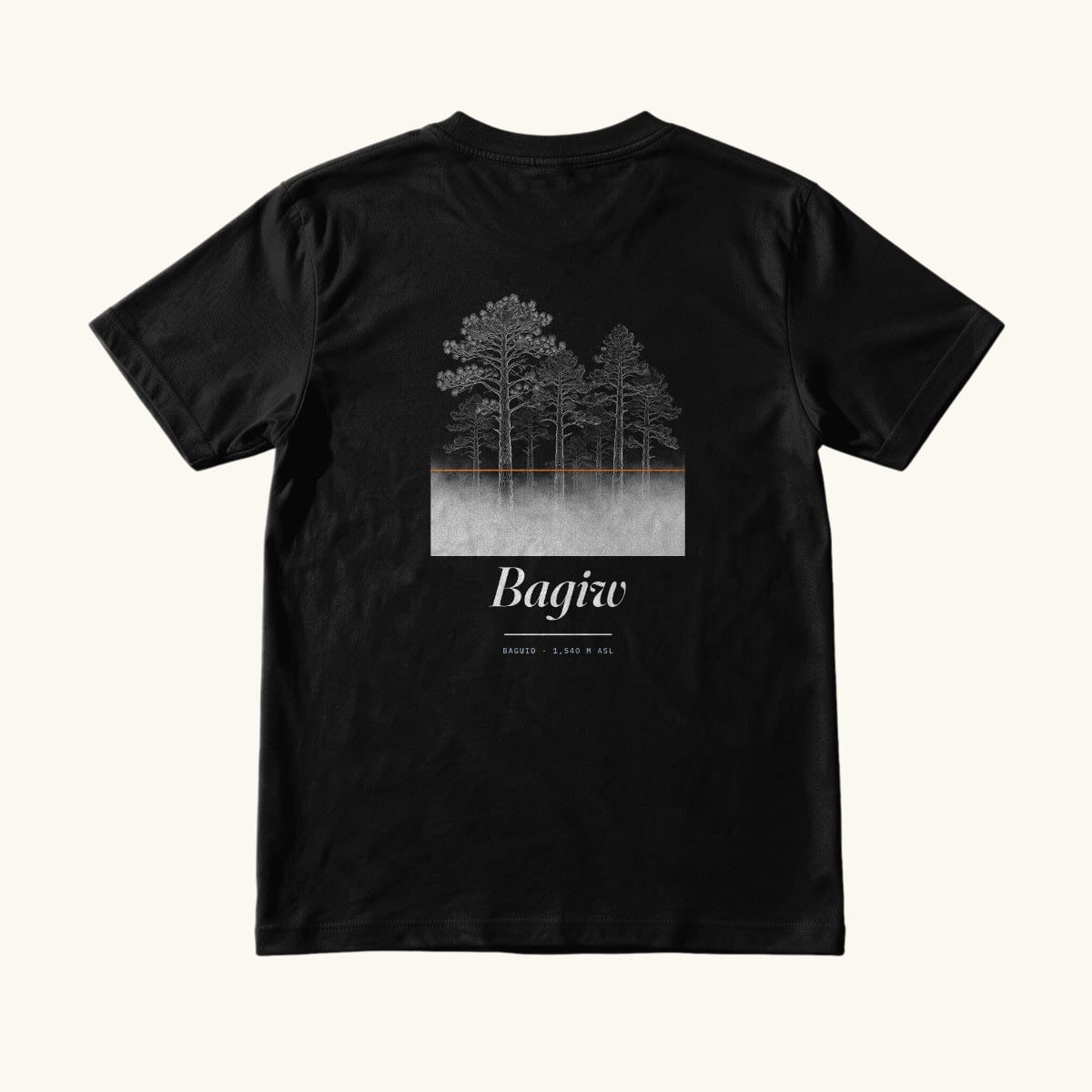 The Suroy Wear Bagiw tee in Midnight Black, back view, Benguet pines above a pale fog band with an orange line where the fog stops and the word Bagiw below it