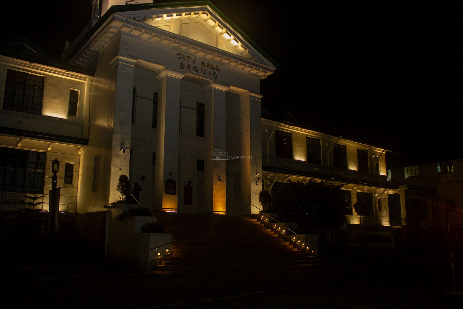 The Mansion in Baguio illuminated at night behind its ornate gate