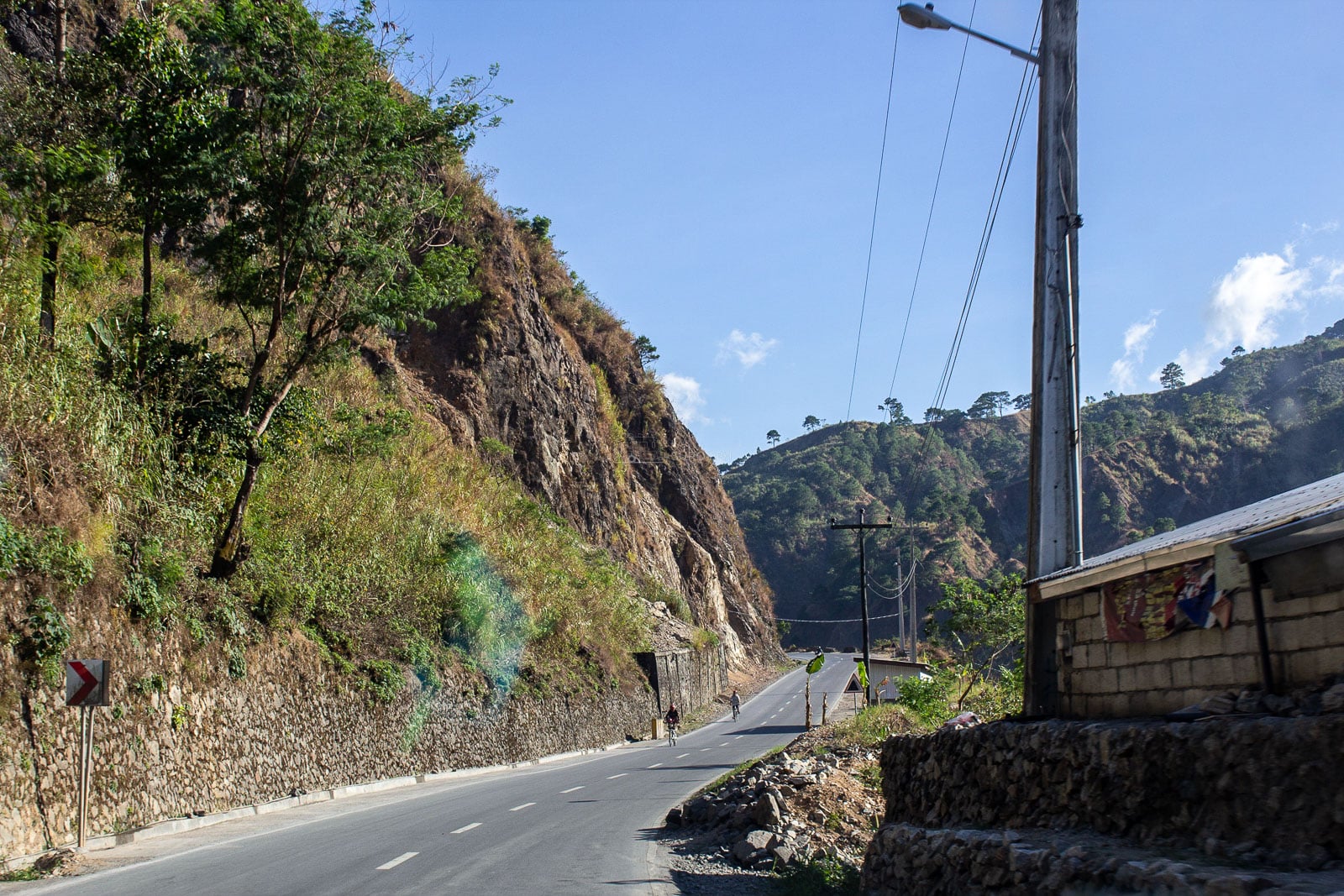 Mountain road cutting through green Cordillera slopes