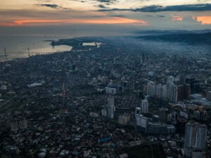 Aerial view of Cebu City, its harbor and surrounding mountains at sunset