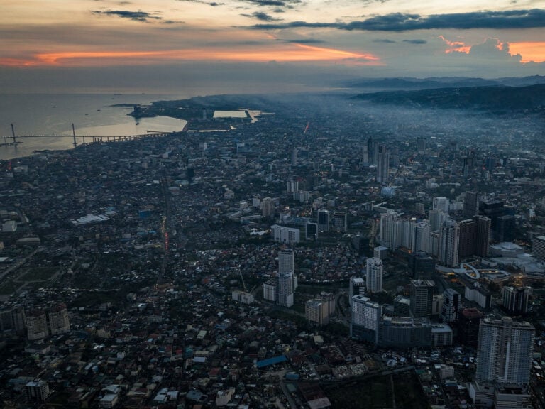 Aerial view of Cebu City, its harbor and surrounding mountains at sunset