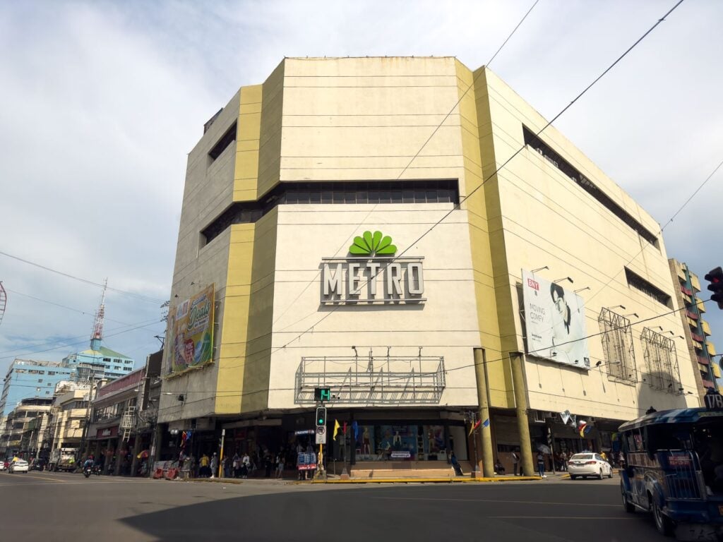 Six-storey cream and yellow Metro department store building on the corner of Colon Street above street-level shopfronts