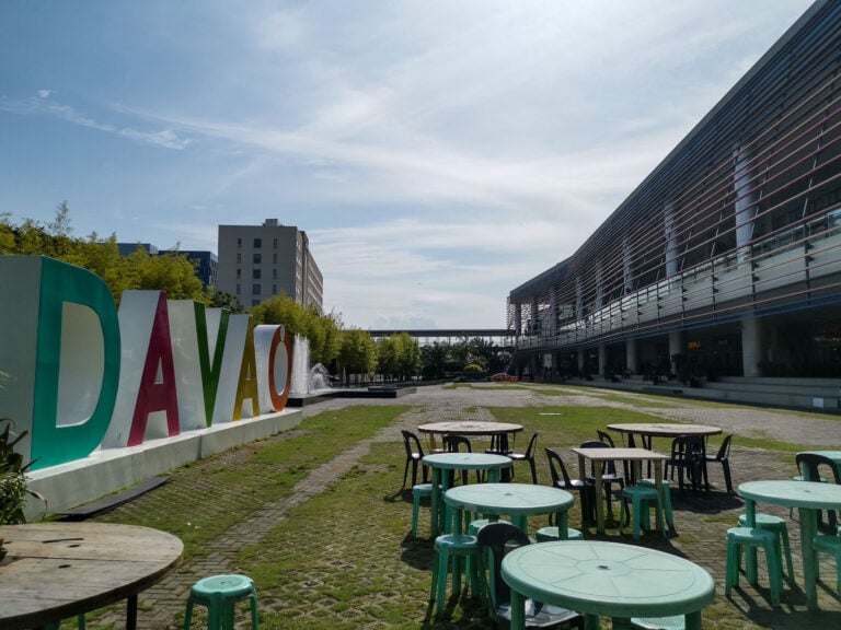 Large multicolored DAVAO letters beside an outdoor plaza