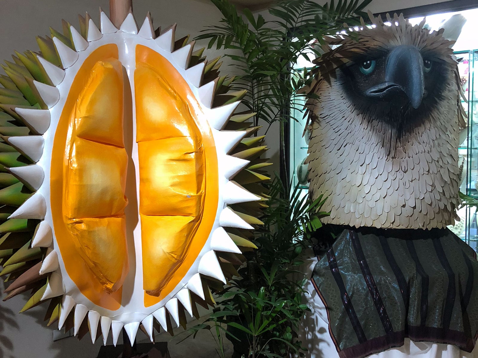 Oversized durian and Philippine eagle sculptures displayed indoors in Davao