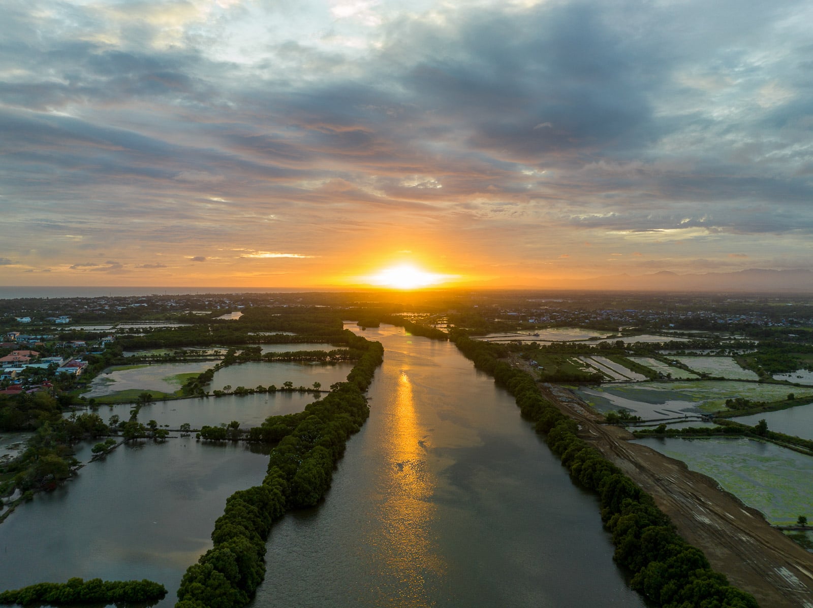 Aerial sunset over the Iloilo River and surrounding wetlands