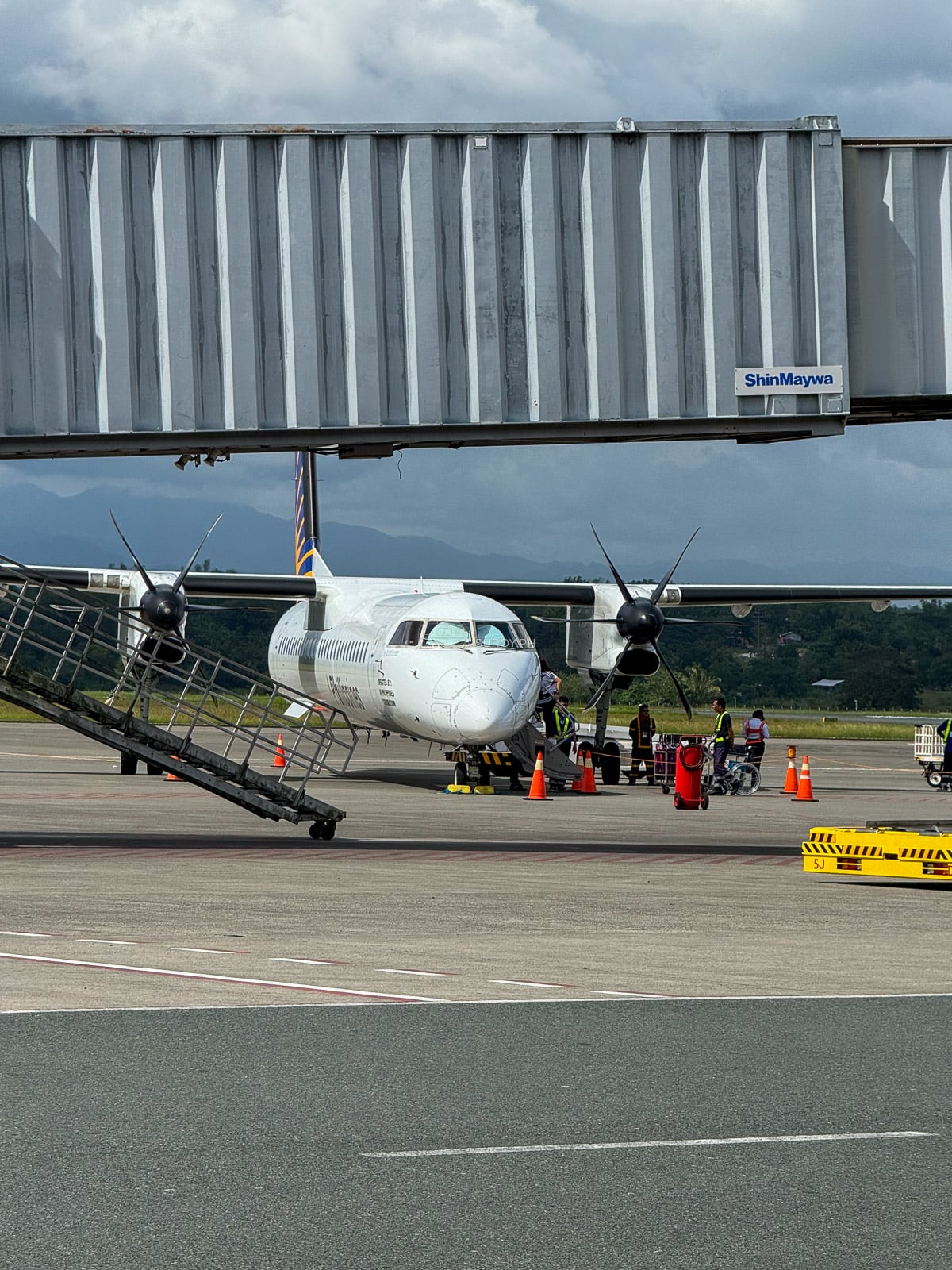 Twin-engine turboprop aircraft parked on the apron at Iloilo International Airport