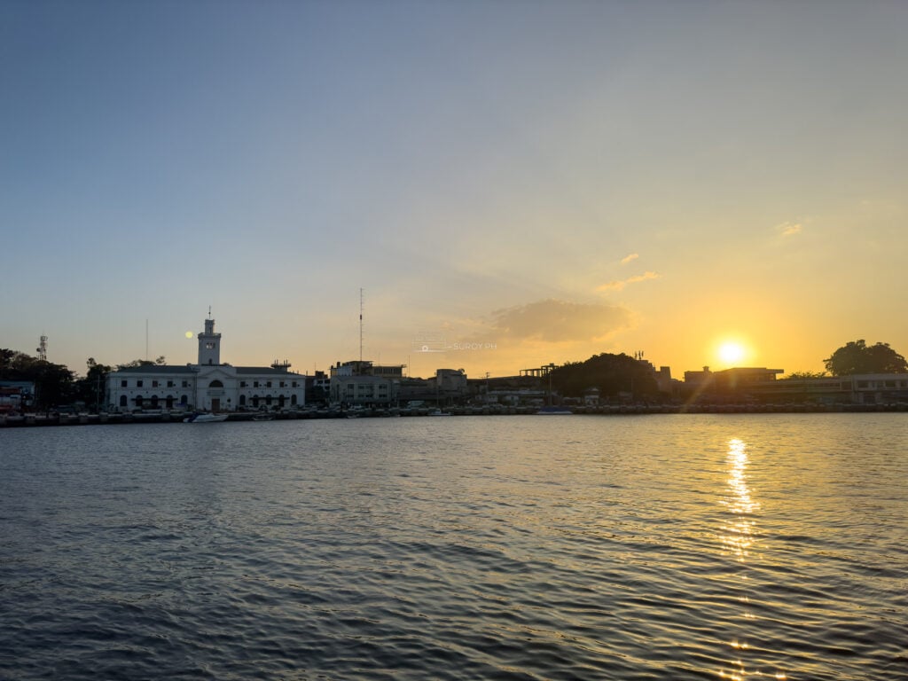 Sunset over the Iloilo Strait, the old customs house and port buildings low on the far bank