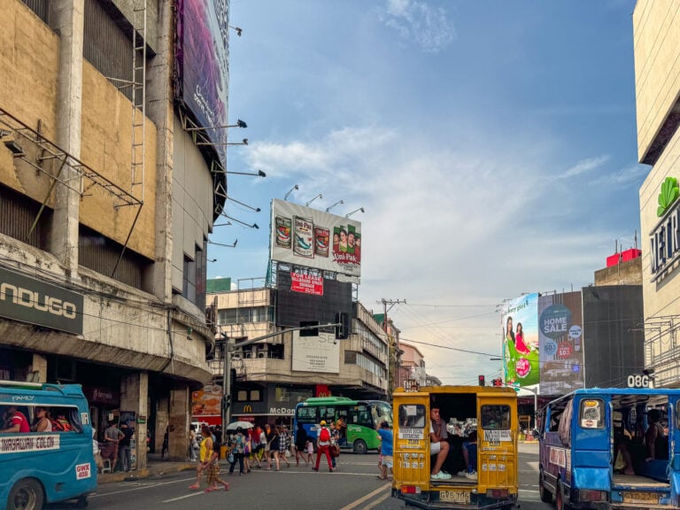 Jeepneys and commuters at a busy intersection in downtown Cebu City