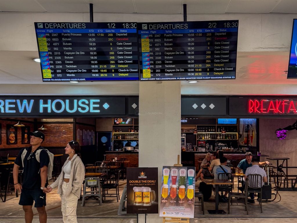 Flight information screens above the dining area at Mactan-Cebu International Airport