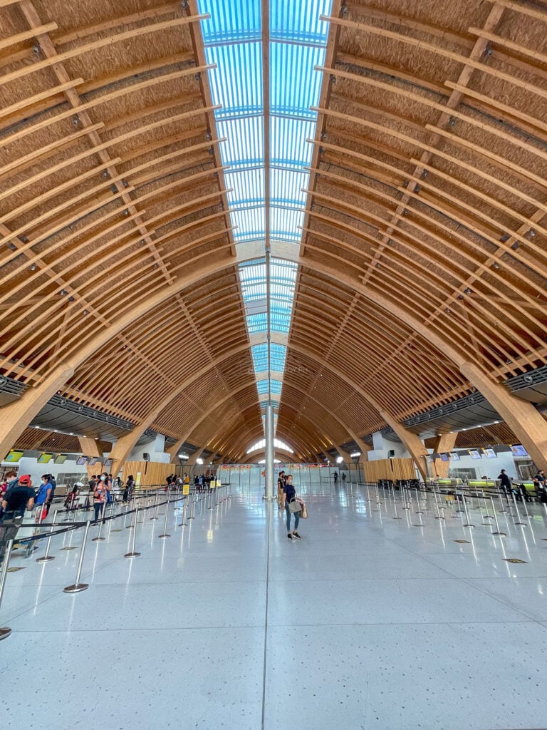 Long passenger hall beneath the timber arches of Terminal 2