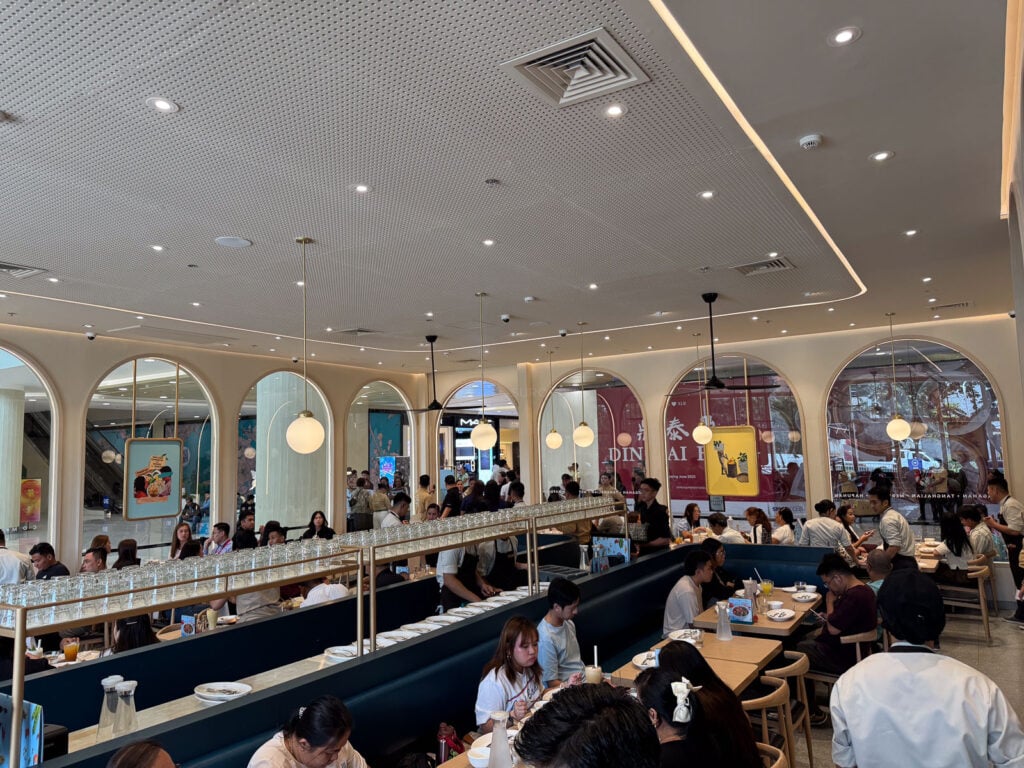 The long service counter running down one side of the Manam dining room at SM City Cebu with diners seated along it