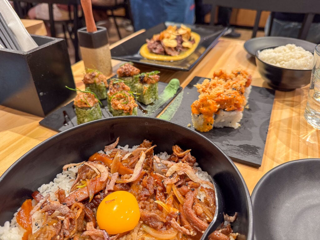 A gyudon rice bowl at Ooma SM City Cebu, thin beef and onion over rice with a raw egg yolk in the centre