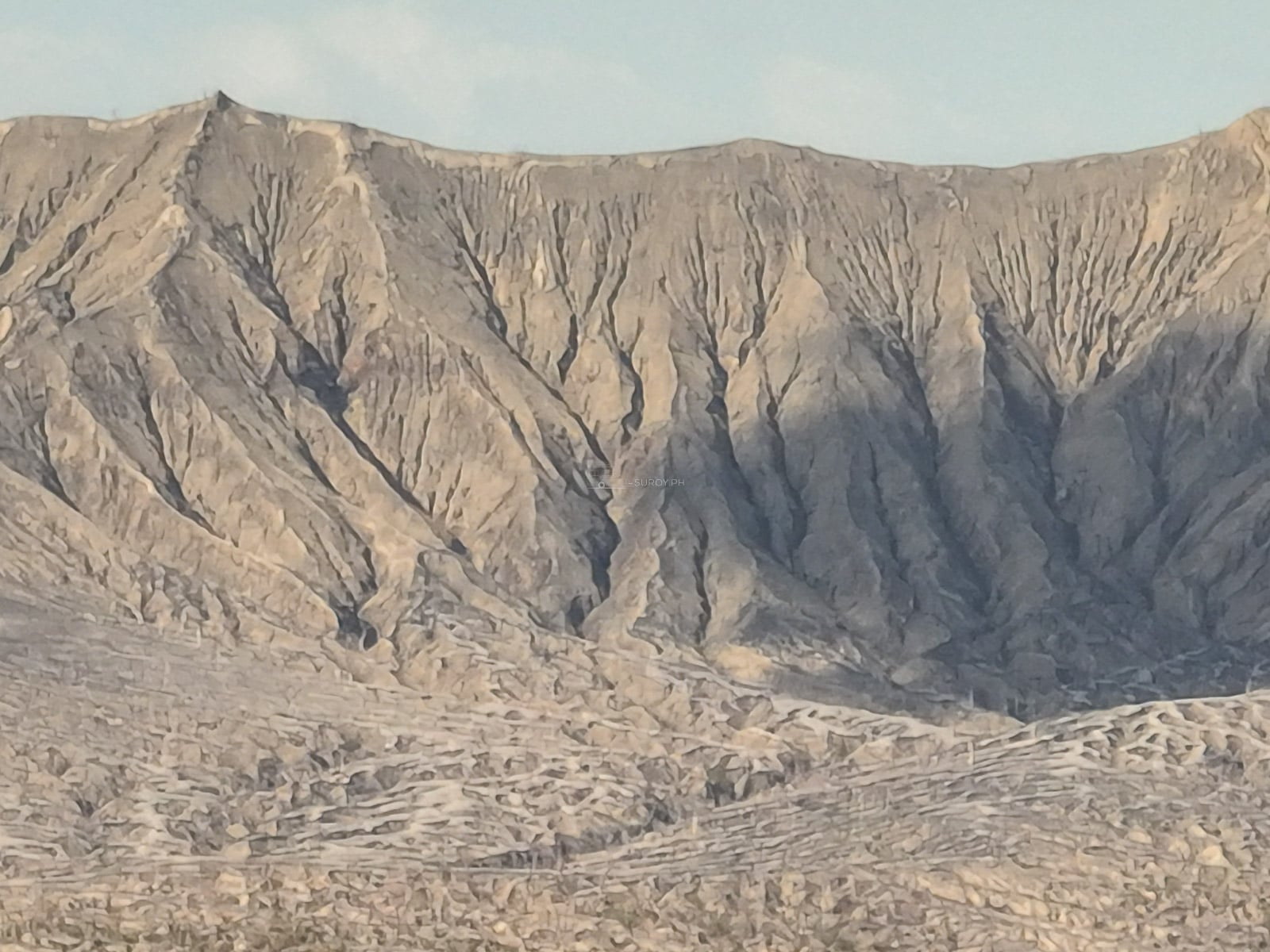 Close view of the deeply gullied grey ash crater cone of Taal Volcano