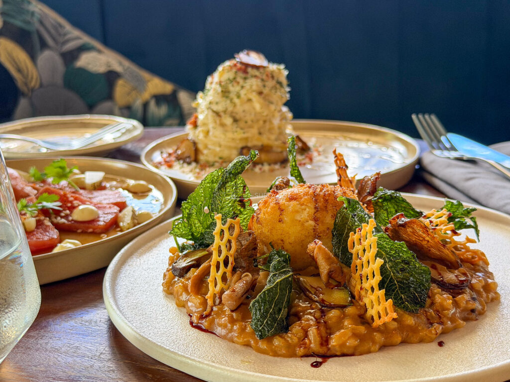 A risotto built into a tower with a prawn standing on top at Tales and Feelings in Cebu City