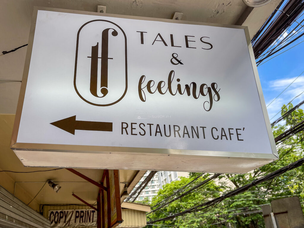 The white light box sign for Tales and Feelings restaurant cafe hanging over F. Ramos Street in Cebu City