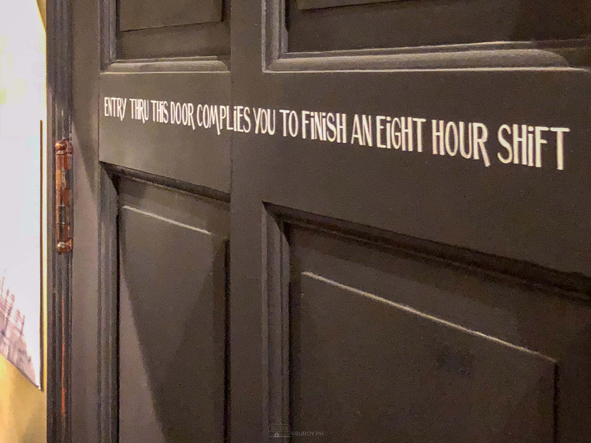 A dark service door at Balai painted with the line entry thru this door complies you to finish an eight hour shift