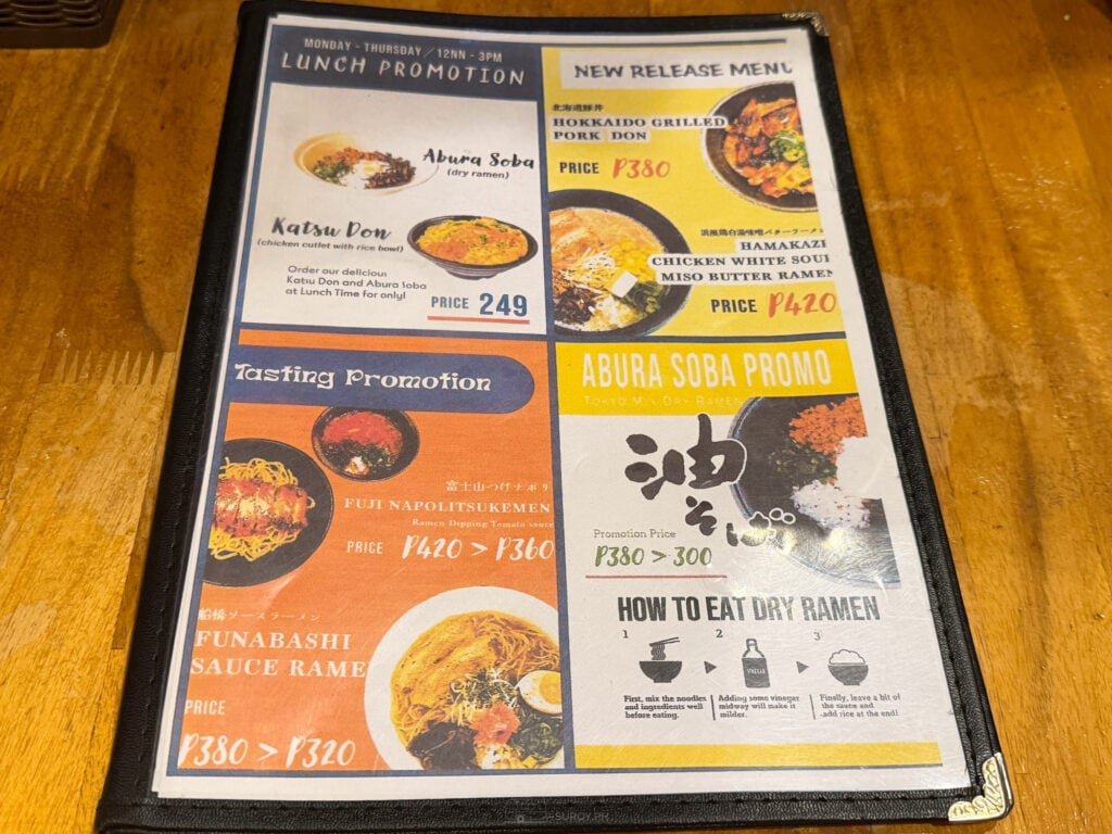 The promotions card at Hamakaze Ramen showing the Monday to Thursday lunch promotion, new release dishes, a tasting promotion and instructions on how to eat dry ramen