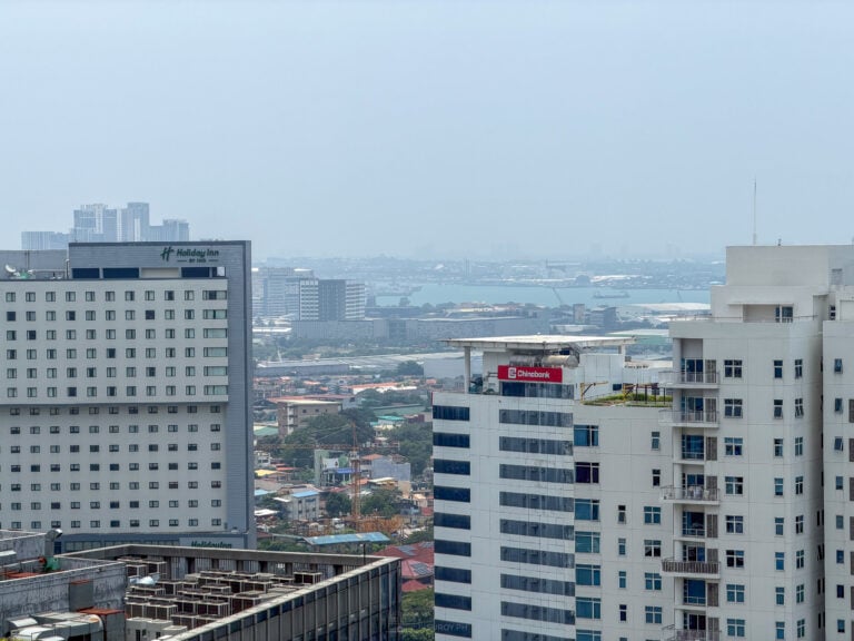 View from Cebu Business Park across the Mactan channel on 4 September 2026, the far shoreline and the sky flattened into gray haze