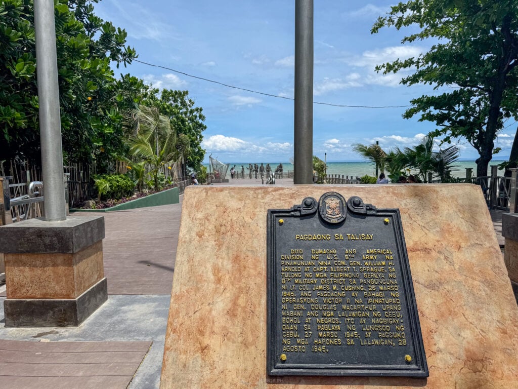 The Pagdaong sa Talisay historical marker on a stone plinth beside the sea at Talisay, Cebu