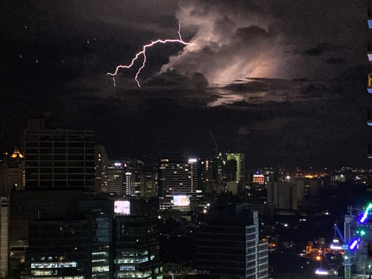 Forked lightning over high-rise buildings in Cebu City at night