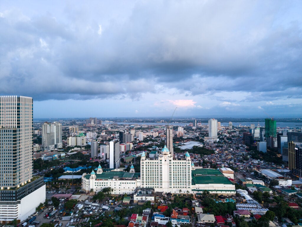 Aerial view of Waterfront Cebu City Hotel and Casino with Cebu City behind it